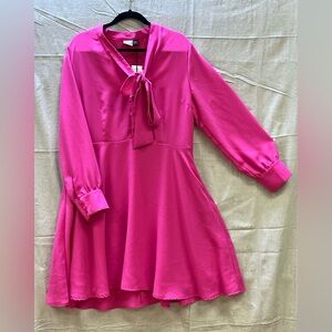 A bright pink polyester dress. Flirty and bright!